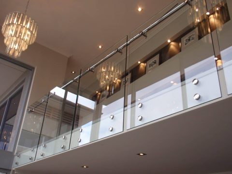 Frameless glass balustrade installed in a contemporary interior.