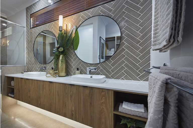 Two round bathroom mirrors and installed glass in a finished home.