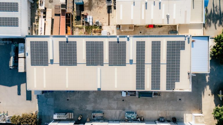 Top-down aerial view of the Tough Glass factory roof and solar array.