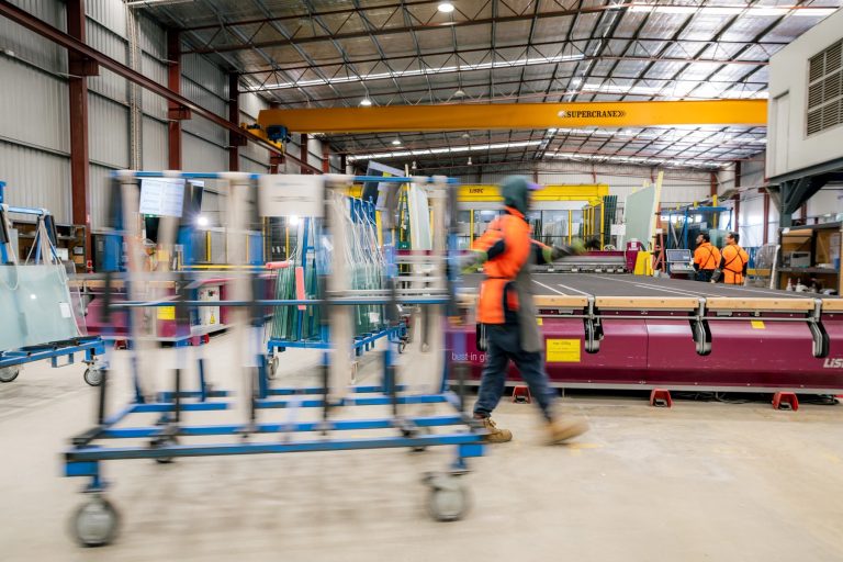 Glass panels moving through the Tough Glass factory floor.