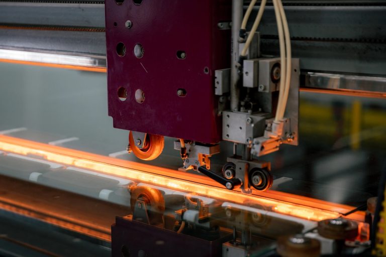 Close-up of heated glass moving through a Tough Glass processing line.