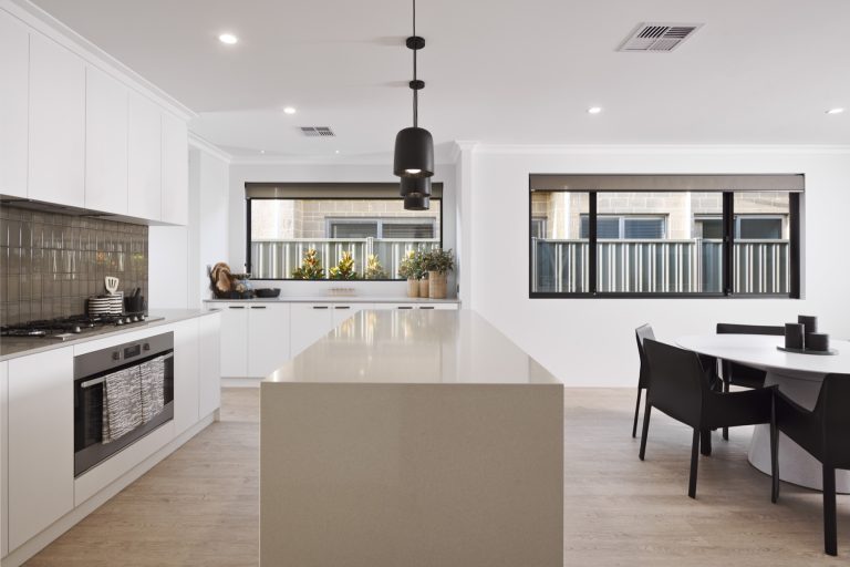 Modern kitchen and dining space with broad black-framed windows.