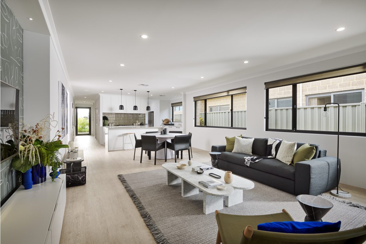 Bright open-plan living area with large black-framed windows bringing natural light into the home.