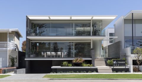 Modern coastal home with extensive frameless glass balcony balustrades.