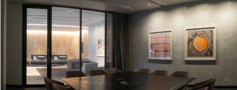 Boardroom separated by clear switchable privacy glass.