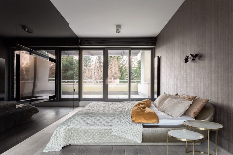 Black vinyl backed glass feature wall in a contemporary bedroom