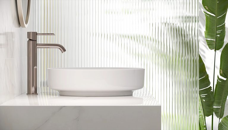 Narrow reeded low iron glass screen beside a marble bathroom vanity