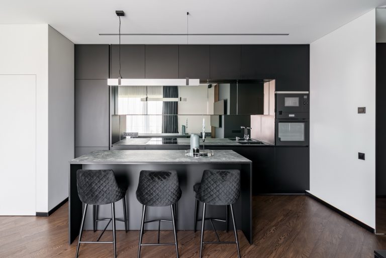 Reflect Silver Plus mirrored splashback in a matte black kitchen