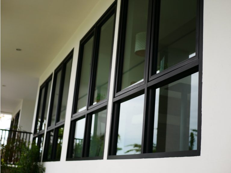 Black-framed windows glazed with grey tinted laminated glass