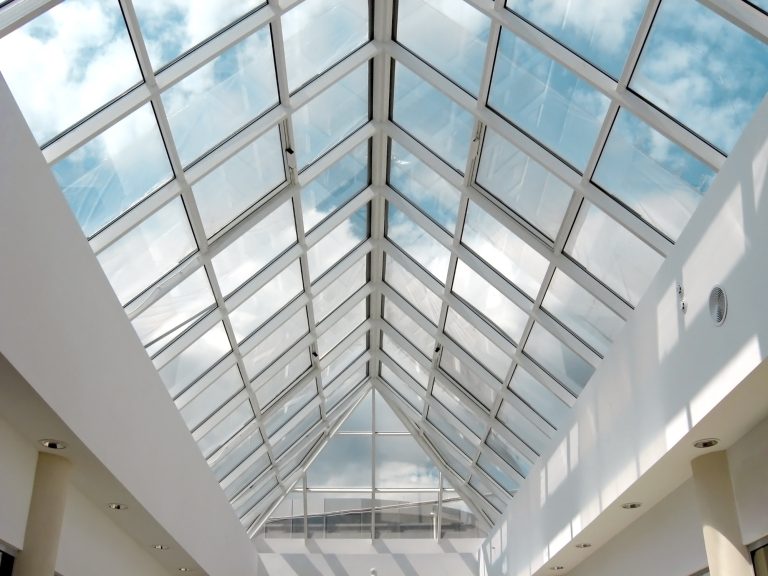Laminated glass skylight vaulting above a bright atrium