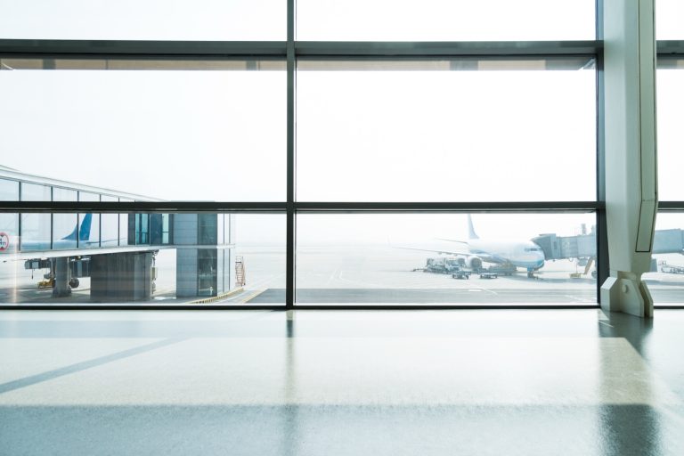 Acoustic laminated glazing quieting an airport terminal beside the runway