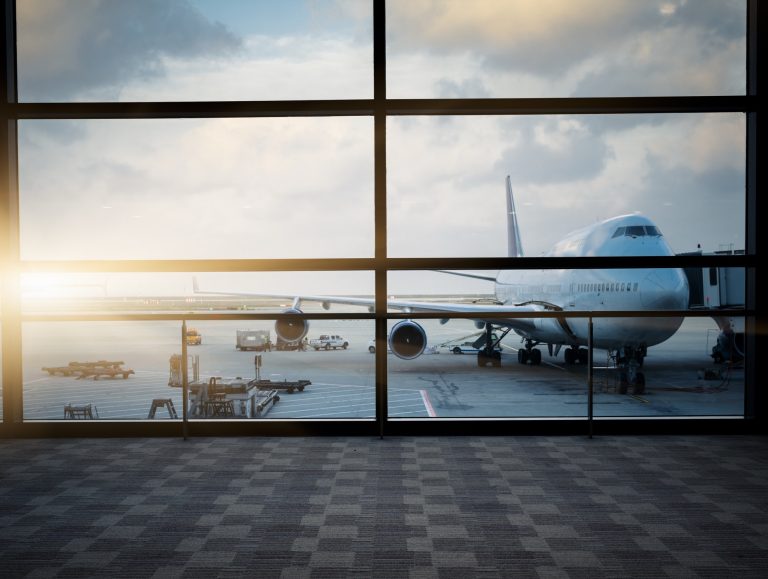 Aircraft on the tarmac seen through acoustic laminated terminal glass