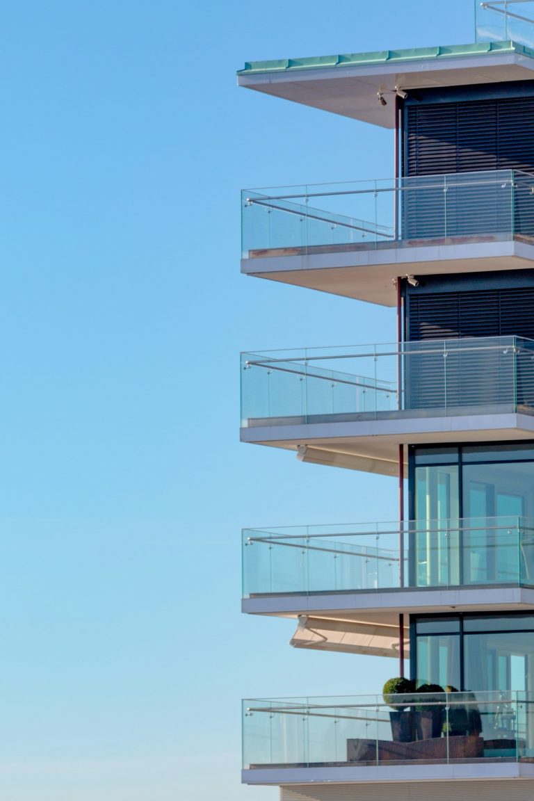 Glass balconies with clear balustrades on a modern apartment building